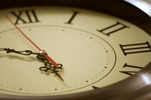 Numeral Clock Face – Legal Delay Tactics in Mesothelioma Cases - Ferraro Law Firm Close-up of a clock face with Roman numerals and a red second hand, symbolizing time-related delays in mesothelioma litigation.