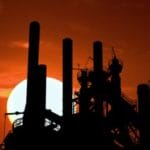 Industrial Factory Silhouette at Sunset – Asbestos Worker Case - Ferraro Law Firm factory smoke stacks during dusk