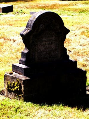 Old gravestone in a cemetery surrounded by grass, symbolizing wrongful death claims such as Riggs v. Georgia-Pacific.