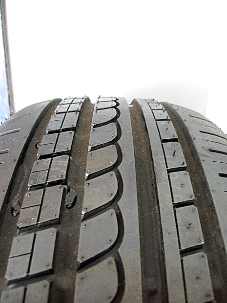 Close-Up of Worn Vehicle Tire Tread - Ferraro Law Firm Close-up view of a vehicle tire tread showing wear and potential defects, symbolizing tire-related safety hazards.
