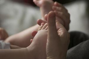 Parent Holding Baby’s Feet – Child Safety Standards - Ferraro Law Firm parent holding baby toes and feet in hands