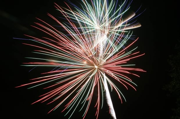 Colorful Fireworks Explosion in Night Sky - Ferraro Law Firm Large red, green, and blue fireworks bursting in the night sky, representing celebrations that can sometimes lead to injuries caused by negligence or defective products.