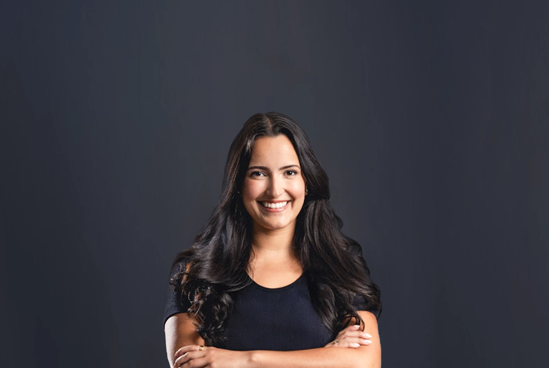 Nikki Hurtado Ready to Deliver Opening Statement - Ferraro Law Firm Smiling attorney standing with arms crossed against a dark background, symbolizing courtroom confidence and skill in opening statements.